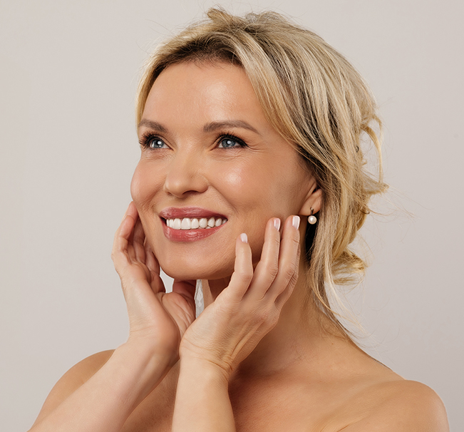 Hand holding Ozempic injection pen used for weight loss, linked to facial fat loss and sagging skin.